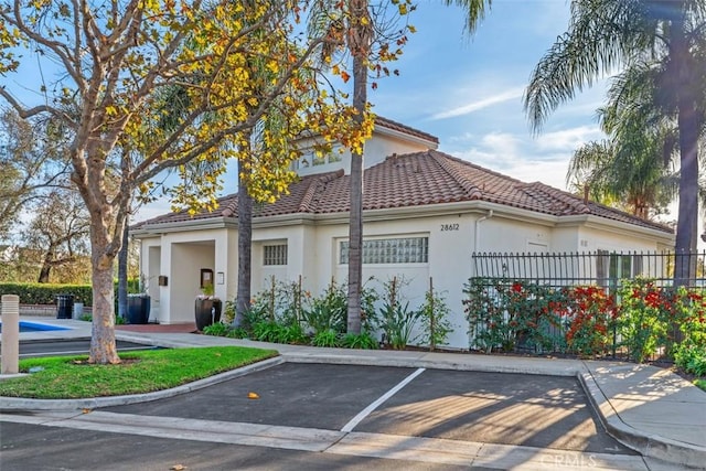 19256 Jasper Hill Rd, Lake Forest, CA 92679 - view of home's exterior with stucco siding, uncovered parking, and a tiled roof