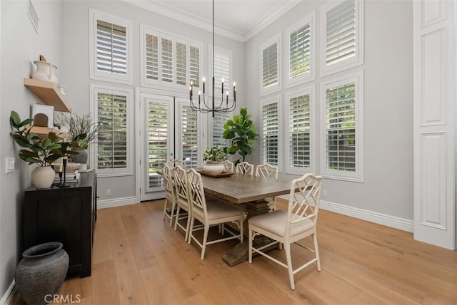 19256 Jasper Hill Rd, Lake Forest, CA 92679 - dining area with a chandelier, light wood-style flooring, ornamental molding, healthy amount of natural light, and a towering ceiling