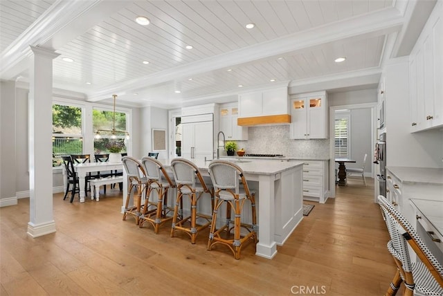 19256 Jasper Hill Rd, Lake Forest, CA 92679 - kitchen with an island with sink, light wood-style flooring, healthy amount of natural light, recessed lighting, and a wood ceiling with exposed beams