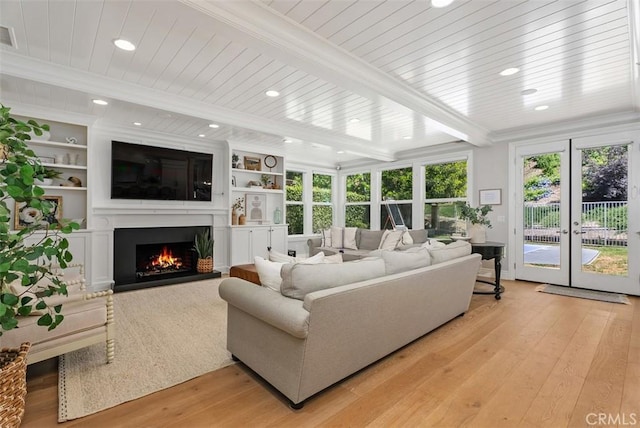 19256 Jasper Hill Rd, Lake Forest, CA 92679 - living room with light wood-style flooring, a lit fireplace, french doors, beam ceiling, and recessed lighting