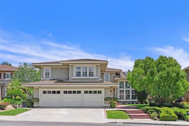 19256 Jasper Hill Rd, Lake Forest, CA 92679 - view of front of home featuring a garage, driveway, stucco siding, and a tiled roof