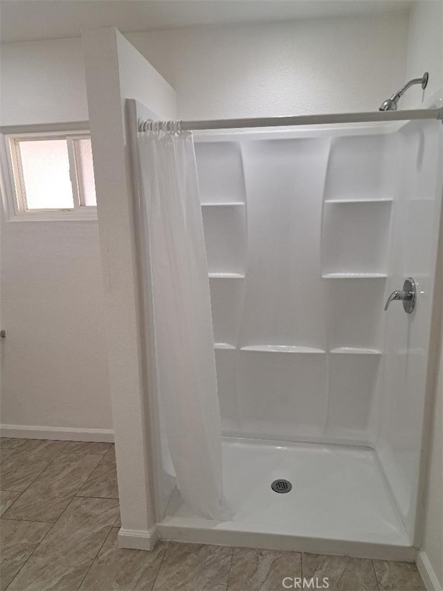 11938 Weller Pl, Moreno Valley, CA 92557 - bathroom with a shower stall and baseboards