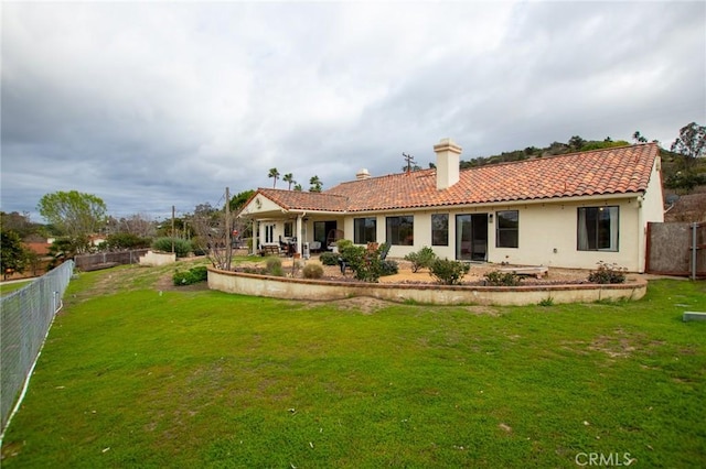 5027 Sleeping Indian Rd, Fallbrook, CA 92028 - back of house with a chimney, a tiled roof, a fenced backyard, stucco siding, and a patio