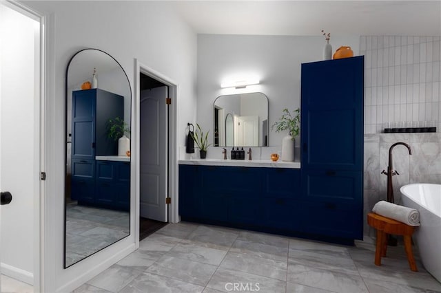 5027 Sleeping Indian Rd, Fallbrook, CA 92028 - full bath featuring marble look tiles, a freestanding bath, and vanity