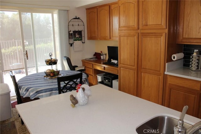 31256 Firestone St, Temecula, CA 92591 - kitchen with light countertops, backsplash, and brown cabinets