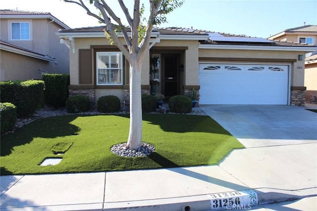31256 Firestone St, Temecula, CA 92591 - view of front facade with stucco siding, stone siding, roof mounted solar panels, and a garage