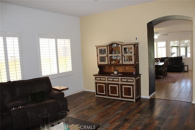 31256 Firestone St, Temecula, CA 92591 - living room with arched walkways, dark wood-style flooring, and a ceiling fan