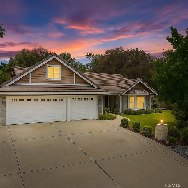 5825 Paseo De La Cumbre, Yorba Linda, CA 92887 - view of front of property with stone siding, concrete driveway, a tile roof, and a yard