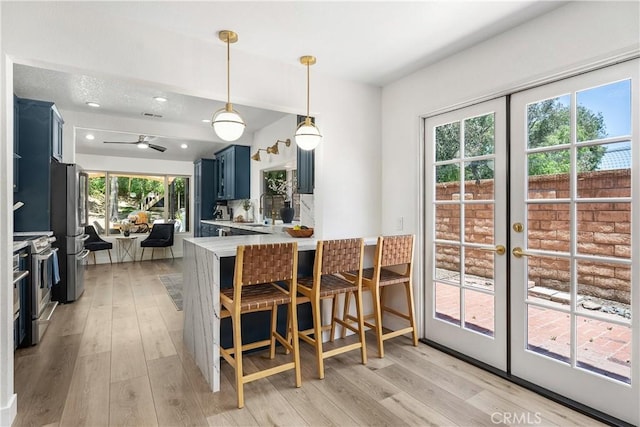 5825 Paseo De La Cumbre, Yorba Linda, CA 92887 - kitchen featuring stainless steel appliances, blue cabinetry, light countertops, light wood-type flooring, and recessed lighting