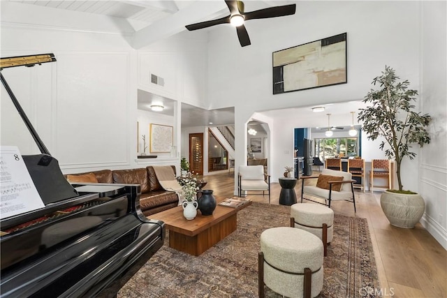 5825 Paseo De La Cumbre, Yorba Linda, CA 92887 - living room featuring wood finished floors, a ceiling fan, a decorative wall, arched walkways, and beam ceiling
