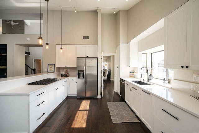 2044 Columbus Way, Vista, CA 92081 - kitchen featuring appliances with stainless steel finishes, a towering ceiling, a peninsula, dark wood-type flooring, and white cabinets