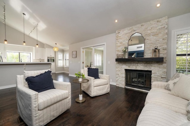 2044 Columbus Way, Vista, CA 92081 - living room with lofted ceiling, dark wood finished floors, and a stone fireplace