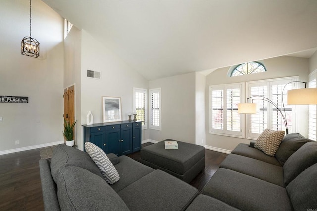 2044 Columbus Way, Vista, CA 92081 - living area with dark wood-type flooring, high vaulted ceiling, and a chandelier