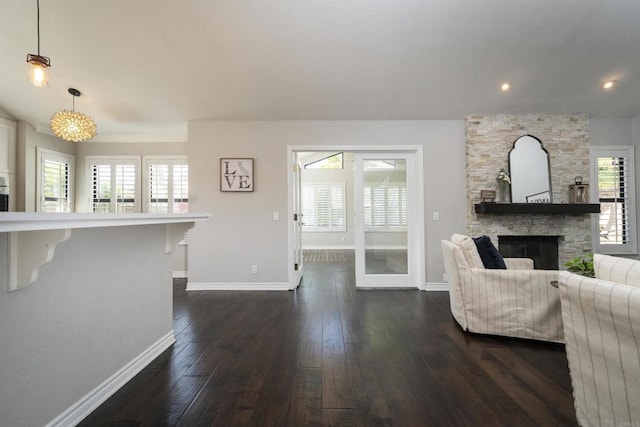 2044 Columbus Way, Vista, CA 92081 - living room featuring dark wood-type flooring, a stone fireplace, and recessed lighting