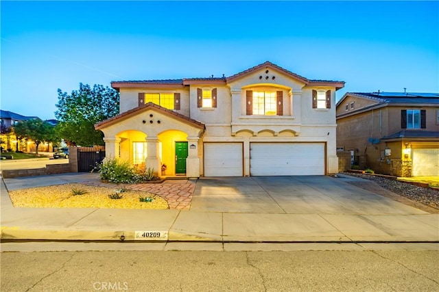 40209 Chelsea Ct, Palmdale, CA 93551 - mediterranean / spanish home featuring stucco siding, a garage, a tile roof, and driveway