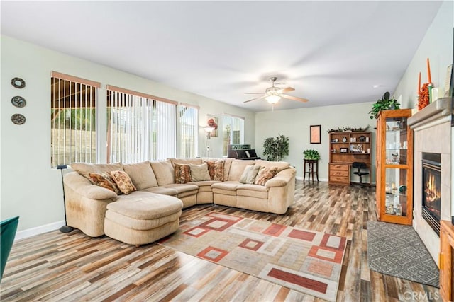 40209 Chelsea Ct, Palmdale, CA 93551 - living room featuring a fireplace, light wood-style flooring, and a ceiling fan