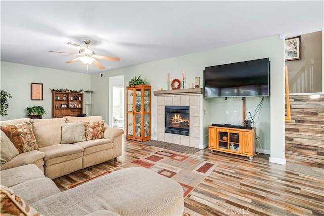 40209 Chelsea Ct, Palmdale, CA 93551 - living area featuring wood finished floors, stairway, a fireplace, and ceiling fan