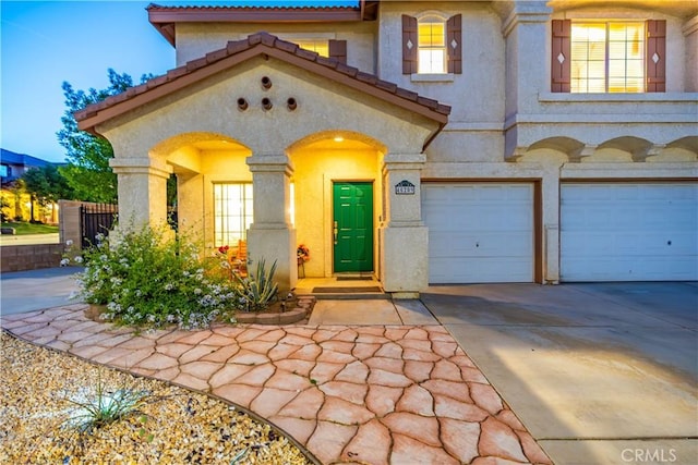 40209 Chelsea Ct, Palmdale, CA 93551 - mediterranean / spanish home featuring a garage, driveway, stucco siding, and a tile roof