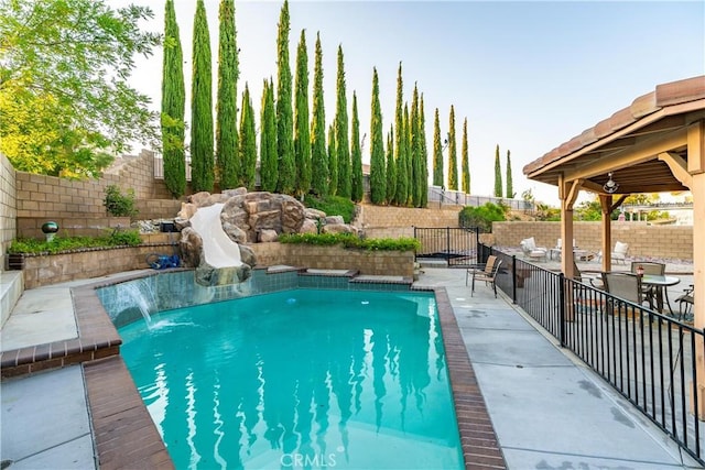 40209 Chelsea Ct, Palmdale, CA 93551 - view of pool with a water slide, a fenced backyard, and a patio area