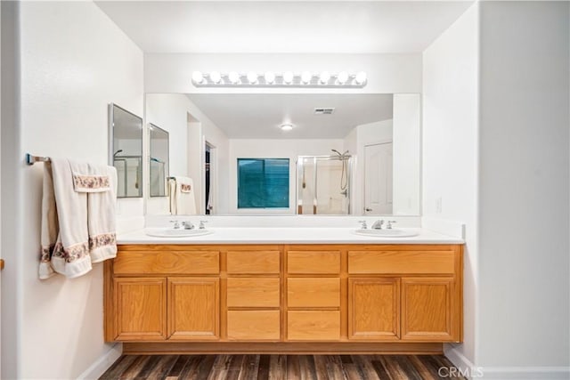 40209 Chelsea Ct, Palmdale, CA 93551 - bathroom featuring double vanity, wood finished floors, and a shower stall