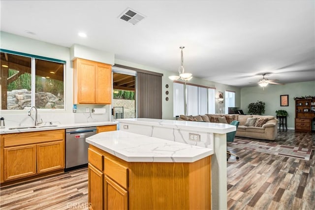 40209 Chelsea Ct, Palmdale, CA 93551 - kitchen featuring stainless steel dishwasher, a kitchen island, light wood finished floors, light countertops, and a ceiling fan