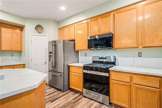 40209 Chelsea Ct, Palmdale, CA 93551 - kitchen featuring stainless steel appliances, light wood-style floors, light stone countertops, and recessed lighting