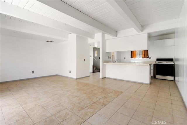 43606 Stanridge Ave, Lancaster, CA 93535 - unfurnished living room featuring beamed ceiling and light tile patterned floors