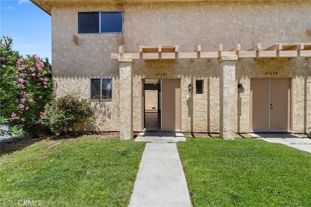 43606 Stanridge Ave, Lancaster, CA 93535 - doorway to property featuring a lawn and stucco siding