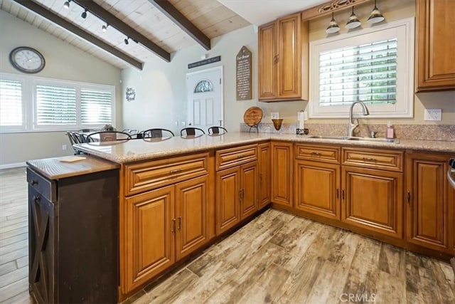 182 Darfo Dr, Crestline, CA 92325 - kitchen featuring light wood-type flooring, brown cabinets, wooden ceiling, a peninsula, and light countertops