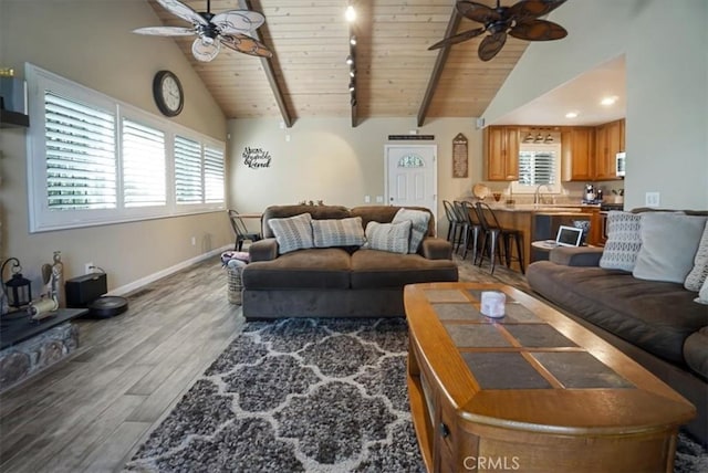 182 Darfo Dr, Crestline, CA 92325 - living area featuring a ceiling fan, wood finished floors, a wood ceiling with exposed beams, plenty of natural light, and high vaulted ceiling