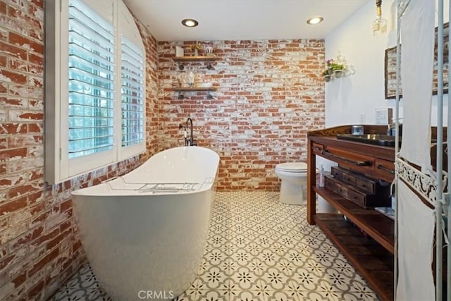 182 Darfo Dr, Crestline, CA 92325 - full bathroom featuring brick wall, vanity, a freestanding tub, tile patterned floors, and recessed lighting