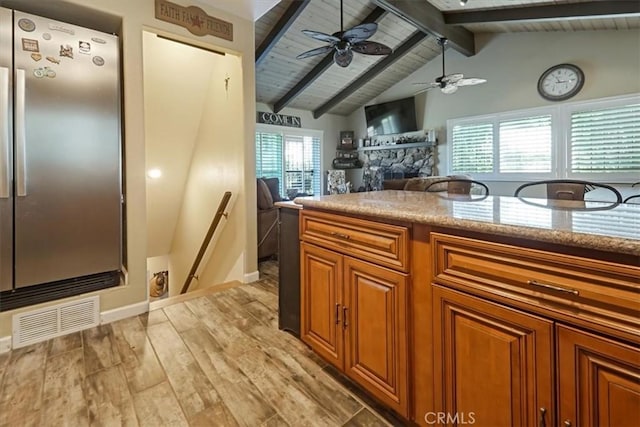 182 Darfo Dr, Crestline, CA 92325 - kitchen with freestanding refrigerator, brown cabinetry, light wood-style flooring, ceiling fan, and wooden ceiling