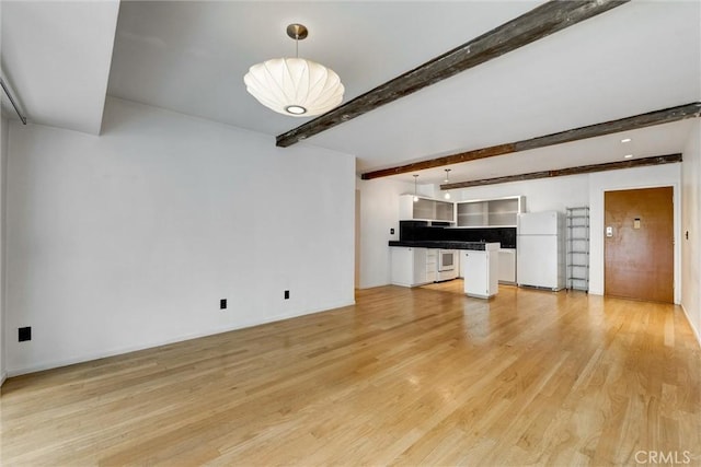 1701 Clinton St Unit 402, Los Angeles, CA 90026 - unfurnished living room with light wood-style floors and beamed ceiling