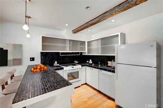 1701 Clinton St Unit 402, Los Angeles, CA 90026 - kitchen featuring white appliances, backsplash, a peninsula, extractor fan, and beamed ceiling