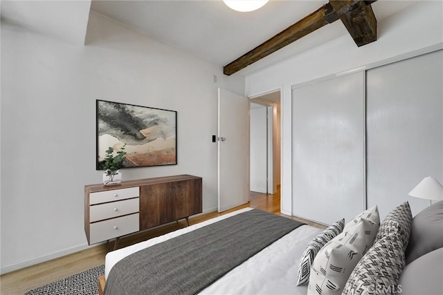 1701 Clinton St Unit 402, Los Angeles, CA 90026 - bedroom with beamed ceiling, wood finished floors, and a closet