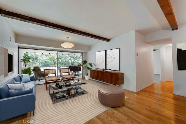 1701 Clinton St Unit 402, Los Angeles, CA 90026 - living area featuring beam ceiling and light wood-style flooring