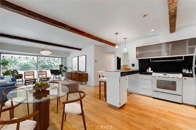 1701 Clinton St Unit 402, Los Angeles, CA 90026 - kitchen featuring electric stove, beamed ceiling, backsplash, a breakfast bar area, and light wood-type flooring