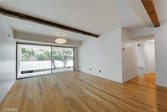 1701 Clinton St Unit 402, Los Angeles, CA 90026 - spare room featuring light wood finished floors and beamed ceiling
