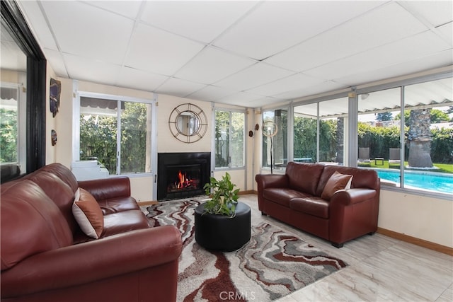 8527 Casaba Ave, Winnetka, CA 91306 - living area with a paneled ceiling, a warm lit fireplace, and healthy amount of natural light