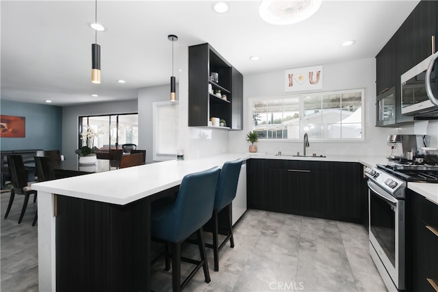 8527 Casaba Ave, Winnetka, CA 91306 - kitchen featuring appliances with stainless steel finishes, modern cabinets, dark cabinets, and recessed lighting