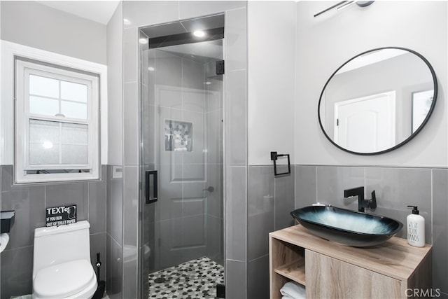 8527 Casaba Ave, Winnetka, CA 91306 - bathroom with tile walls, a shower stall, vanity, and wainscoting