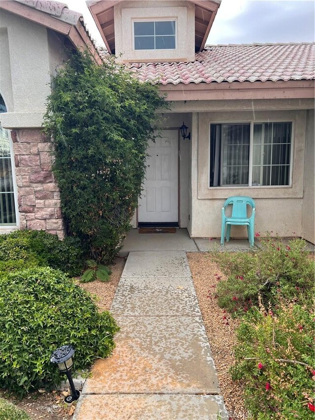 14106 Dartmouth St, Hesperia, CA 92344 - property entrance with a tile roof and stucco siding
