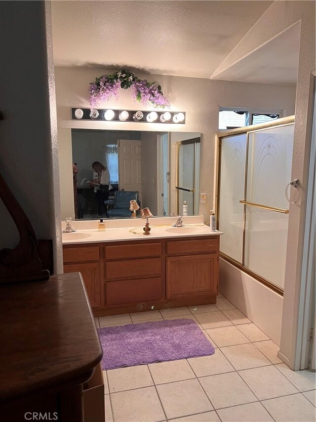 14106 Dartmouth St, Hesperia, CA 92344 - full bathroom featuring double vanity, a textured wall, tile patterned flooring, combined bath / shower with glass door, and a textured ceiling