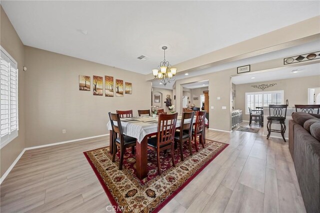 1410 Charles St, Banning, CA 92220 - dining room featuring light wood-type flooring and a chandelier