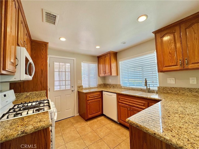 2014 W Hartford Pl Unit 58, Anaheim, CA 92801 - kitchen featuring white appliances, light tile patterned floors, brown cabinetry, and recessed lighting