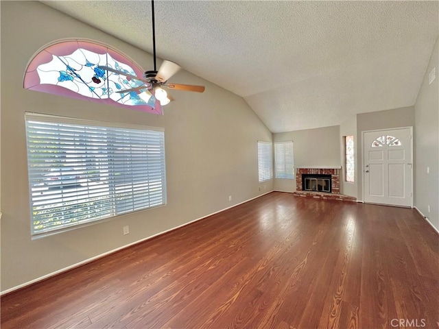 2014 W Hartford Pl Unit 58, Anaheim, CA 92801 - unfurnished living room featuring ceiling fan, a textured ceiling, wood finished floors, vaulted ceiling, and a fireplace