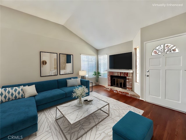 2014 W Hartford Pl Unit 58, Anaheim, CA 92801 - living area featuring wood finished floors, vaulted ceiling, and a brick fireplace