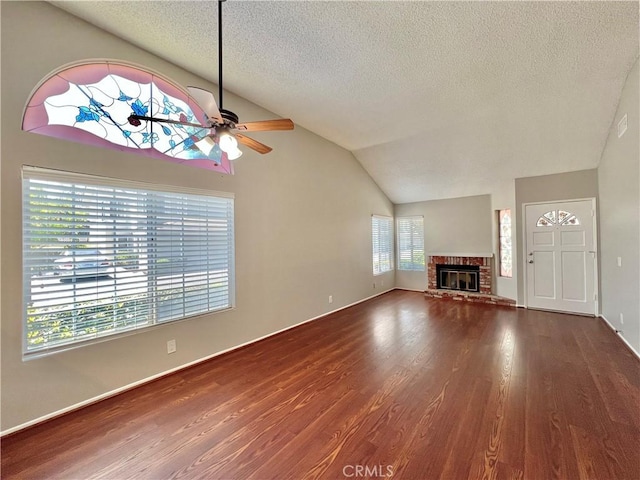 2014 W Hartford Pl Unit 58, Anaheim, CA 92801 - unfurnished living room with ceiling fan, a textured ceiling, lofted ceiling, wood finished floors, and a fireplace