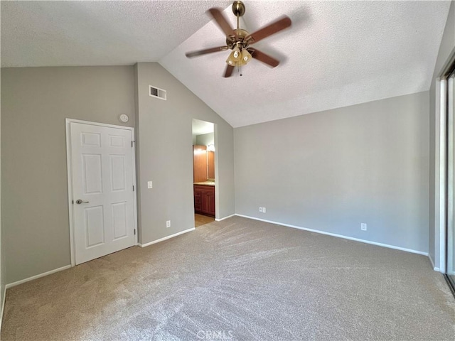 2014 W Hartford Pl Unit 58, Anaheim, CA 92801 - unfurnished bedroom with carpet floors, vaulted ceiling, a textured ceiling, connected bathroom, and ceiling fan