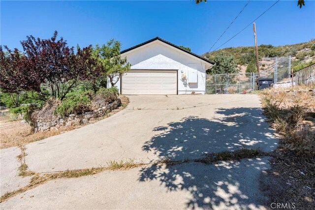 26865 Pine Canyon Rd, Lake Hughes, CA 93532 - view of property exterior with concrete driveway and an attached garage